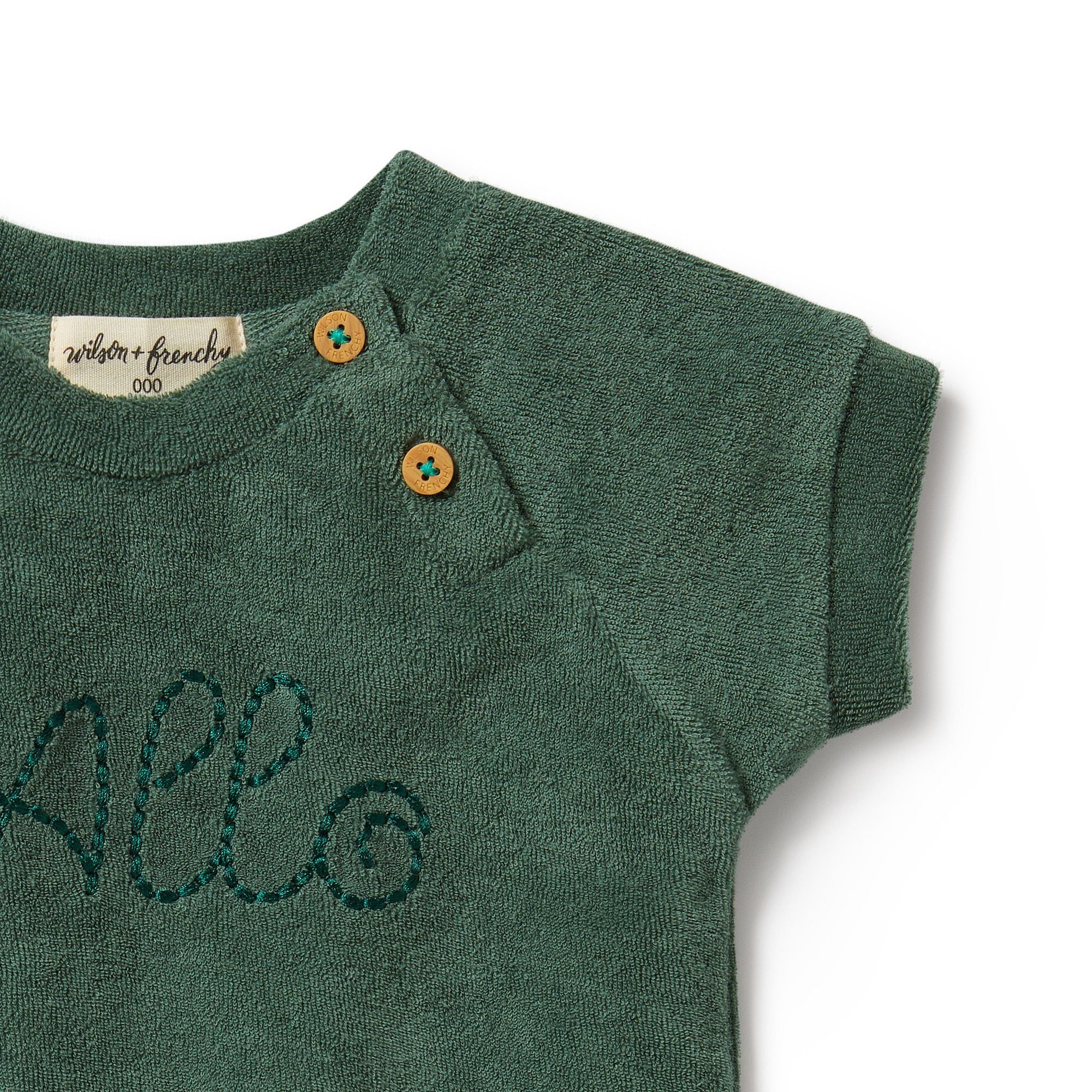 Elevate your little one's wardrobe with the adorable 'Allo' Baby Terry Cloth Green Tee from Wilson & Frenchy. Crafted with soft terry cloth fabric, this charming tee features the word 